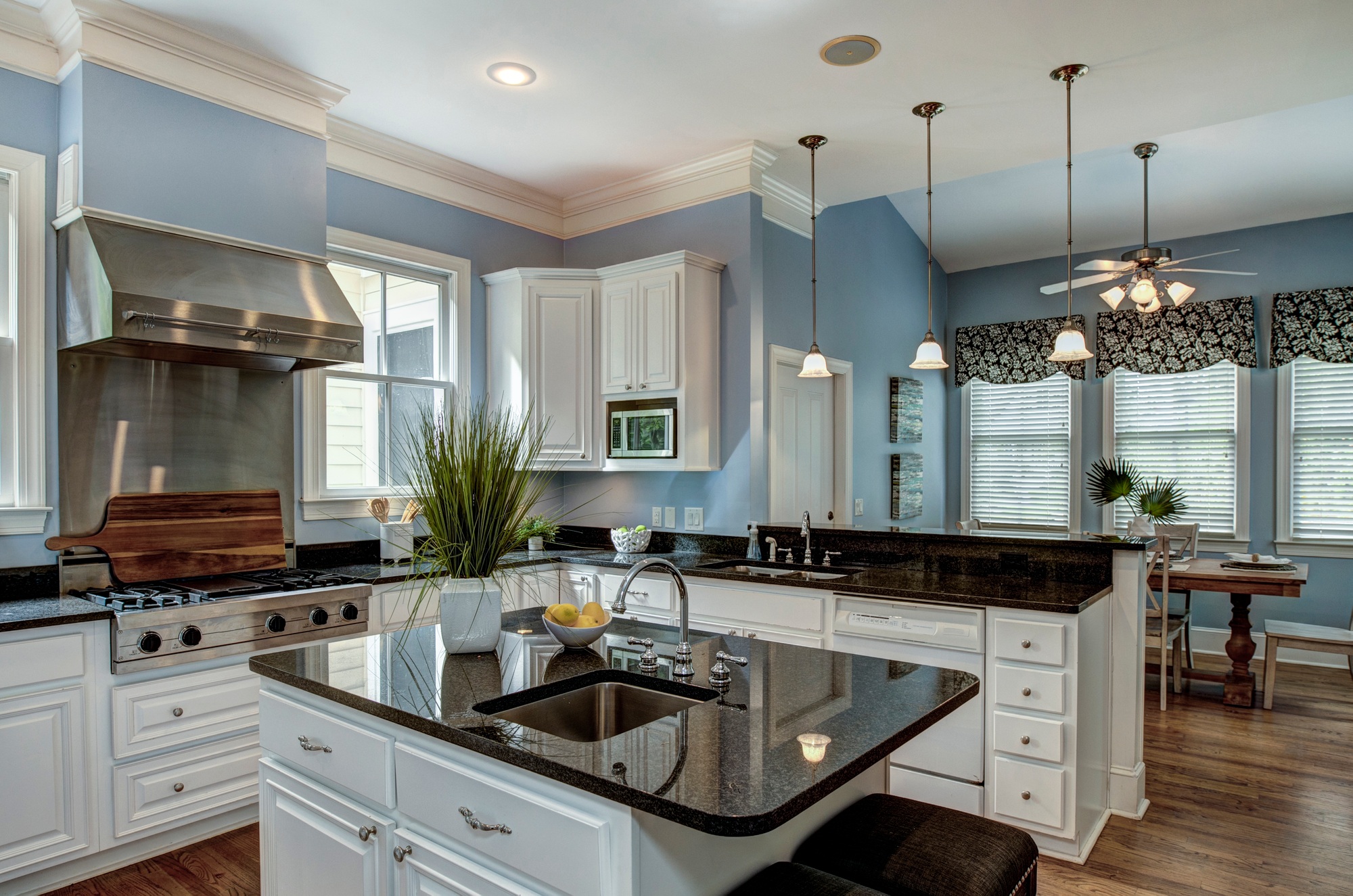 Large American style kitchen and dining room interior with granite countertops